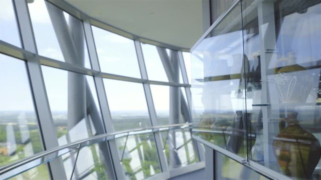 Moving inside a tower glass room with archaeological vases 4K

