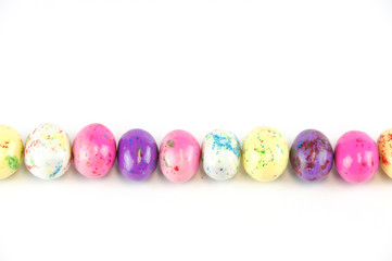 easter candy in egg shape in a row isolated on white background