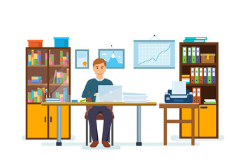 An office worker is working at computer, working with documents.