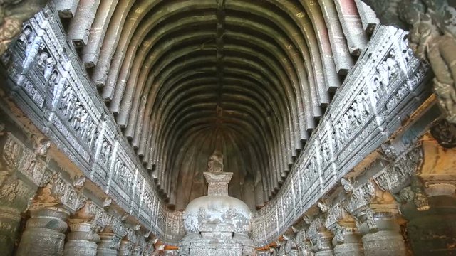 Long hall with columns and arcades inside of Aurangabad caves.