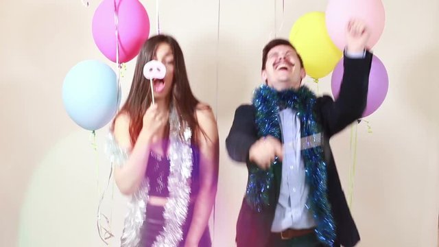 Happy crazy couple enjoying in party photo booth, graded