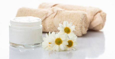 Fototapeta na wymiar Moisturizing cream and chamomile on white background