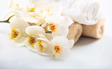 White orchid and towels on white background