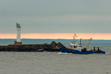 Blue fishing ship sailing in stll water