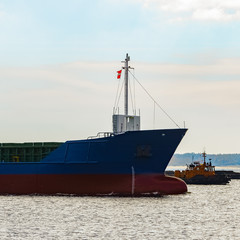 Blue cargo ship's bow leaving the port of Riga