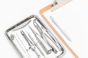 Dental tools, equipment and dental chart on white background