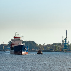 Fototapeta premium Blue cargo ship leaving the port of Riga