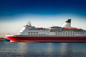 Fototapeta na wymiar Red cruise liner. Passenger ferry ship sailing in still water