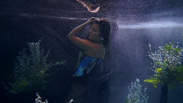 The dream of a young girl. Dive into the weightlessness under water. The flowing graceful movements of the body.
