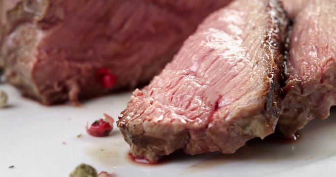 closeup pan of entrecote beef steak sliced on plate, 4k prores footage
