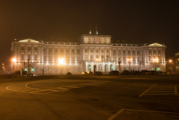 Fototapeta na wymiar Mariinsky palace close up on foggy March night, Saint-Petersburg