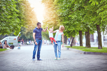 Happy family having weekend in summer park