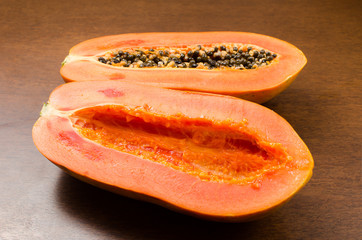 Ripe papaya fruit on wooden gackground ready to eating