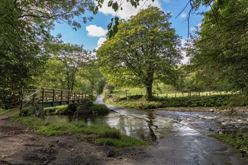 Fototapeta na wymiar Flooded ford and footbridge between Smardale and Crosby Garrett, Yorkshire Dales, Cumbria, UK