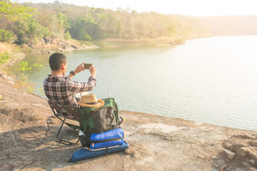 Asian man backpack in nature background, Relax time on holiday concept 