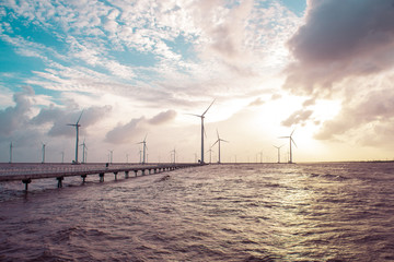 Wind turbines at sunset. Ecology wind against cloudy sky background with copy space