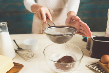 House wife wearing apron making. Steps of making cooking chocolate cake.