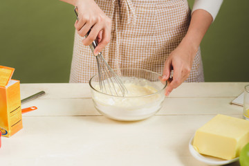 House wife wearing apron making. Steps of making cooking chocolate cake. Preparing dough, mixing ingredients