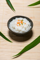 Close up of cooked rice in wooden in bowl on wooden table
