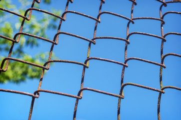 iron chain link fence against sky