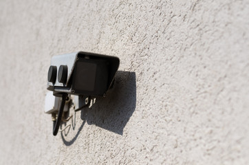 Closed circuit surveillance camera on a wall