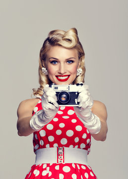 woman, with no-name camera, taking picture, dressed in pin-up style