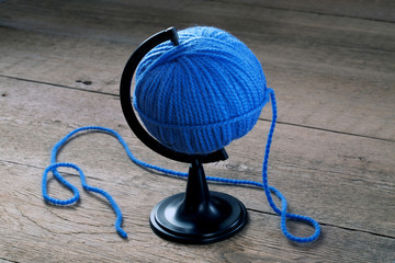 blue ball of yarn on a stand for the Globe