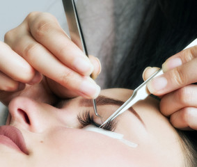 Beautician making artificial lashes. eyelash extension procedure