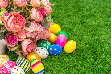 Easter eggs with artificial flower on Fresh Green Grass
