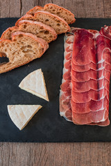 Jamon serrano ham and camembert cheese with rustic wholegrain bread