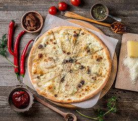 Delicious pizza with nuts and pears, topview