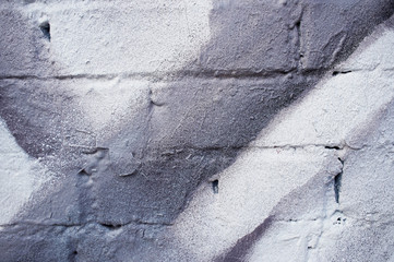Grafiiti. Grey paint stripes on a white brick wall. Old