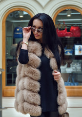 Beautiful young woman in fur vest.