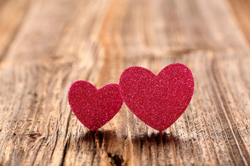 Fototapeta premium valentines day card with two hearts on wooden background