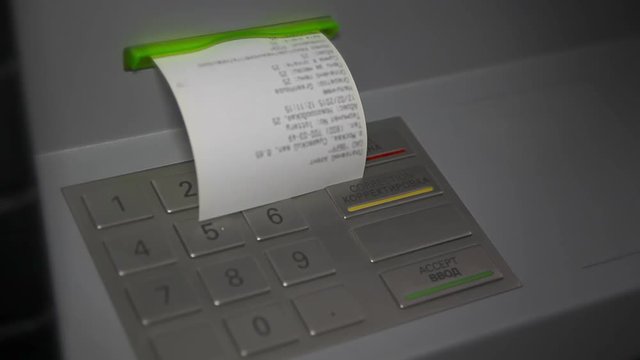 Human hand take receipt from ATM
