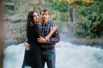 Fototapeta premium pair of beautiful brunette with a guy hugging on the nature
