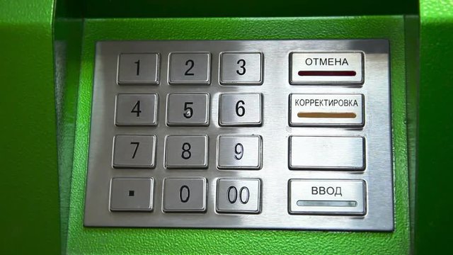 Human hand enter pin code on ATM