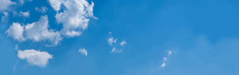 Sky background. Nature composition. Panoramic sunset sky background. Bright blue sky with lighted clouds. 