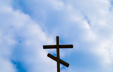 religion wooden cross against the blue sky