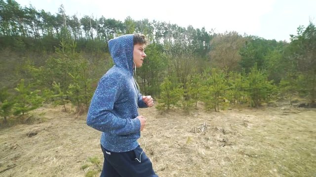 Handsome sportsman running on the nature in the morning
