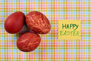 Obraz na płótnie Canvas Painted red eggs. Happy Easter handmade card. Topical Easter attributes.
