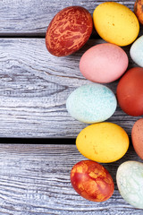 Easter eggs on gray wood. Painted chicken eggs.