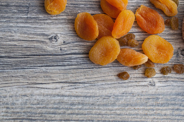 Dried apricots, raisins on a gray board, a proper snack