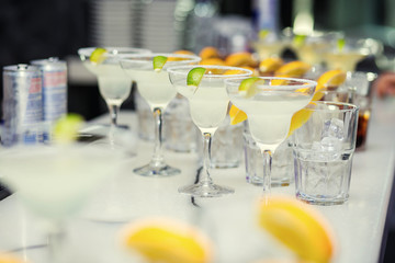Glasses with cocktails, champagne, juice.Glasses on the white table, A row of champagne glasses,cocktails.Furshet, catering.Glasses for champagne or wine.