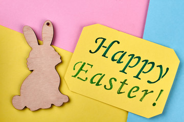 Plywood rabbit cutout, Easter card. Yellow greeting card. Holiday mood and creativity.