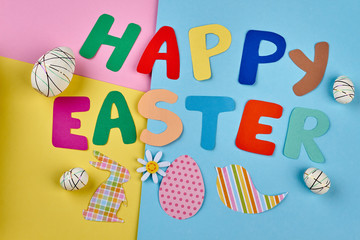Happy Easter colorful letters. Styrofoam eggs and paper cutouts.
