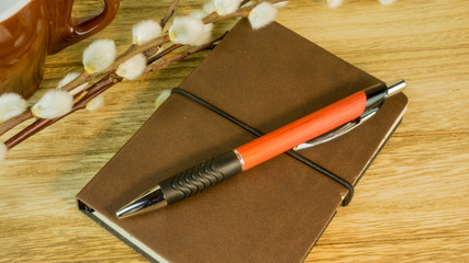Desk with notepad, ballpoint pen and floral accents