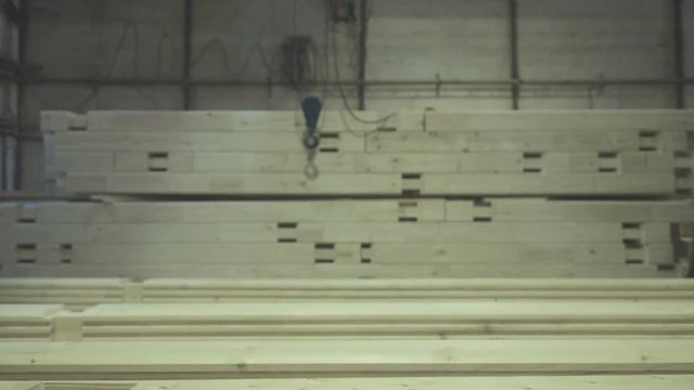 LVL Laminated Veneer Lumbe. Engineered stress-rated product created by bonding together individual pieces of lumber. Large hangar with the production line for wood.