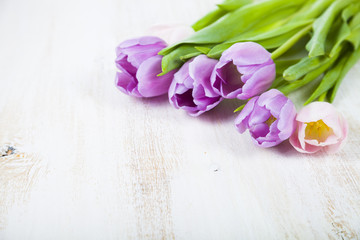 Bouquet of tulips on a wooden background.