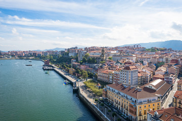 Fototapeta na wymiar The Estuary of Bilbao with the town Portugalete to the right, as seen from the bridge looking south. The Vizcaya Bridge is the worlds oldest transporter bridge, built in 1893